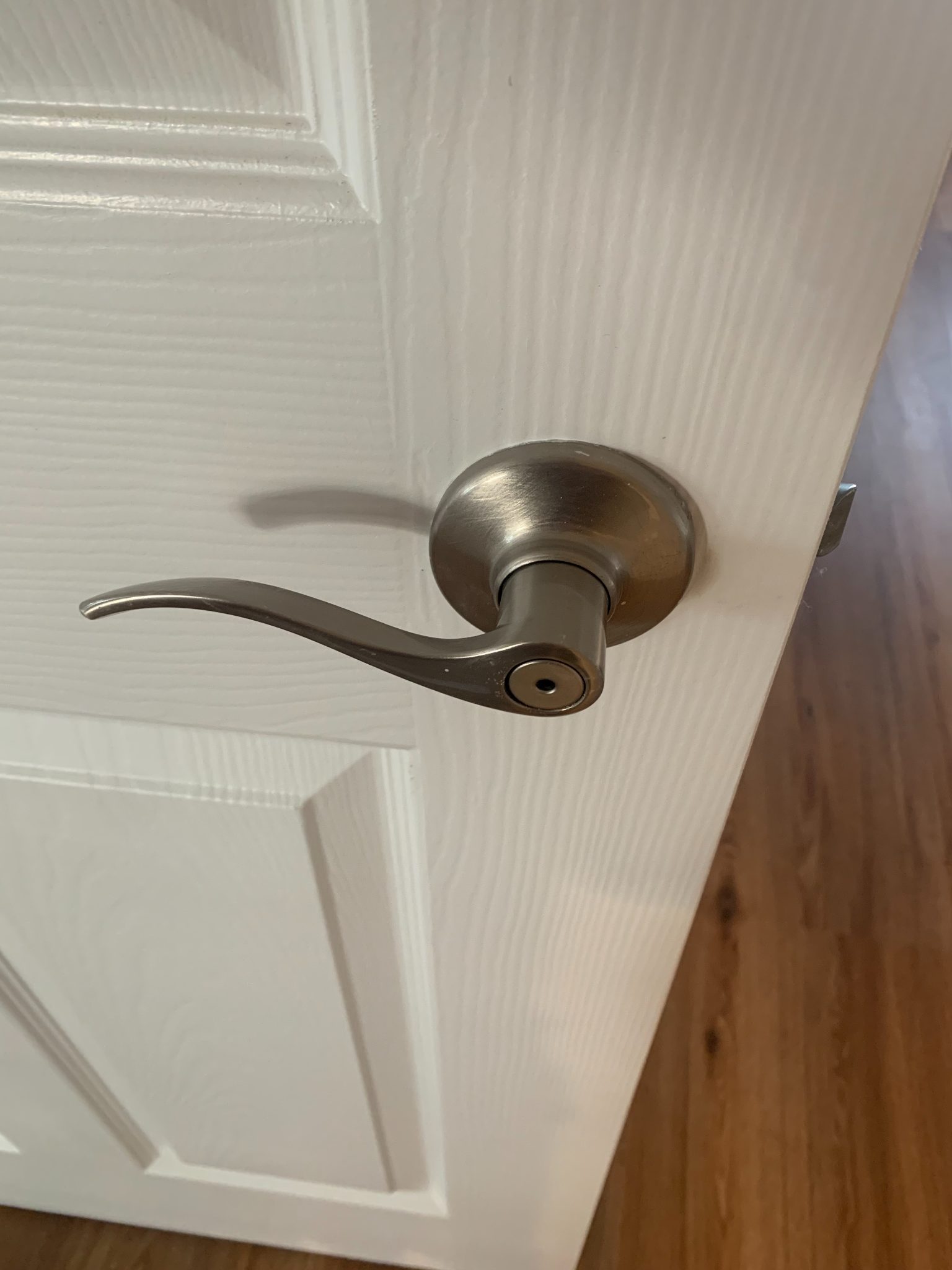 Brushed nickel door lever handle on white interior door